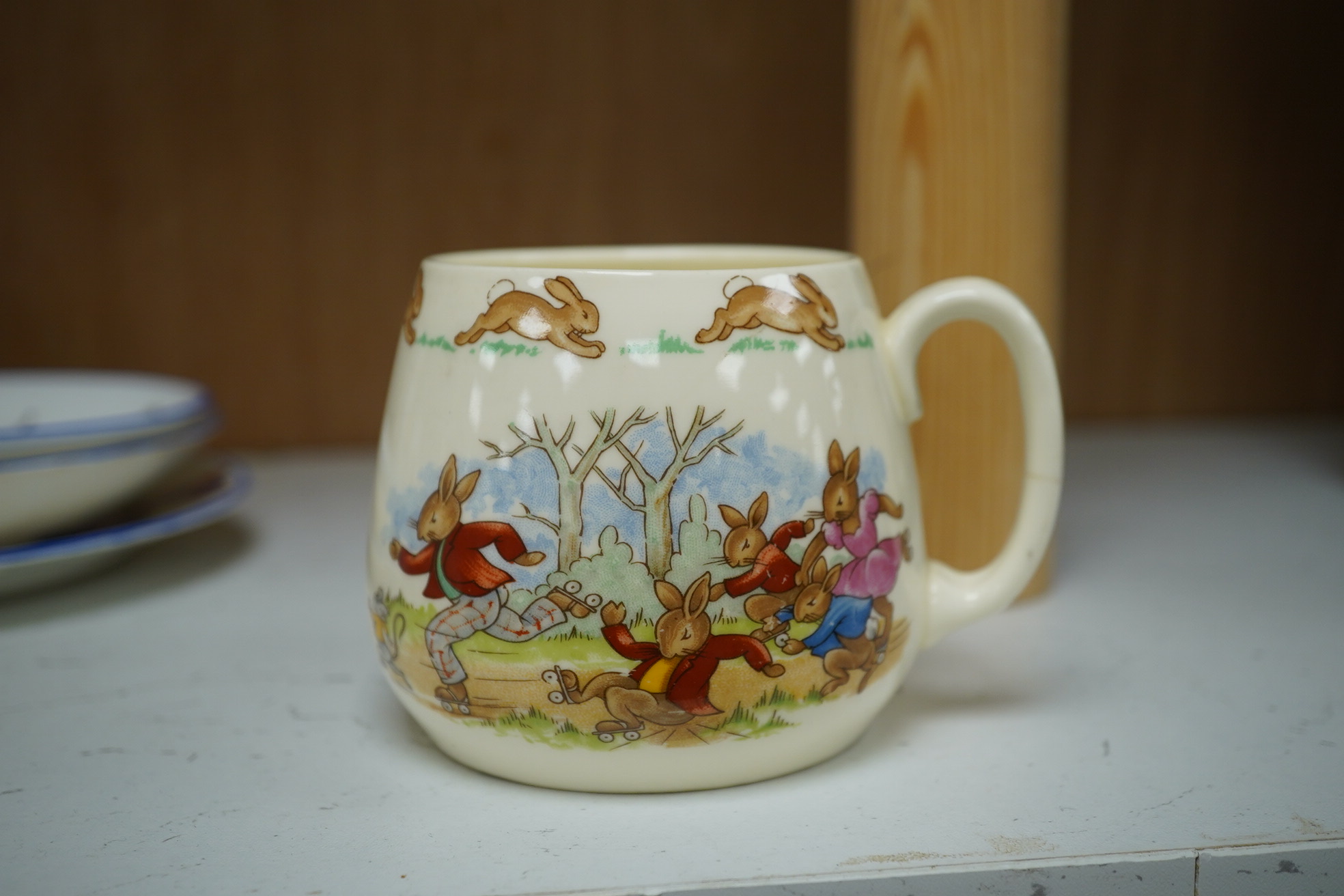 A Marjory Drew New Chelsea children's tea set and a Bunnykins mug. Condition - one cup badly restored